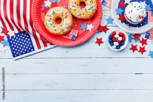 Independence Day background on 4th of July with american flag, stars and food on wooden table top view.