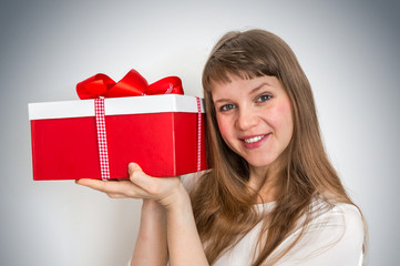 Pretty smiling woman with red gift box