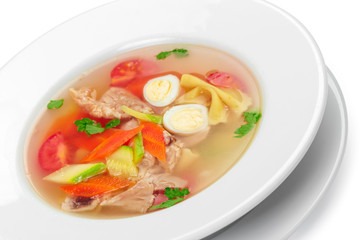 Homemade chicken vegetable soup in a white bowl