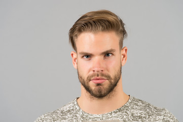 Fototapeta premium Handsome and confident. Man beard unshaven well groomed looks handsome and cool. Guy bearded attractive cares about appearance. Man bristle serious strict face, black background close up