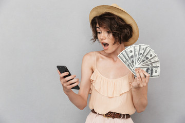 Portrait of a surprised young woman in summer hat