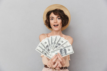Portrait of an excited young woman in summer hat