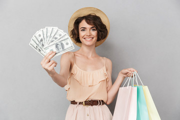 Portrait of an excited young woman in summer hat