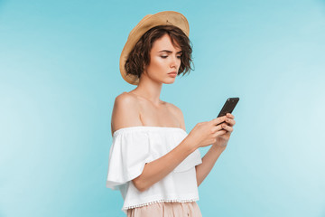Portrait of a serious young woman using mobile phone