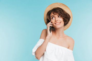 Portrait of a happy young woman in summer hat