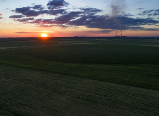 Green Field and colorful sunset. Aerial photo, made by drones