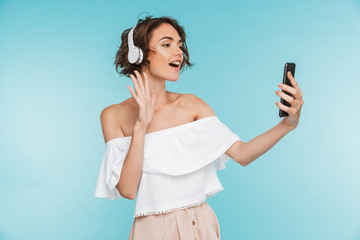 Portrait of a friendly young woman listening to music
