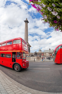 Trafalgar square with red buses in London, England