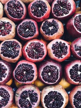 Pomegranates fruit for making fresh squized juice in the street of Istanbul, Turkey. Traditional street food. Healthy lifestyle and summer beverages.