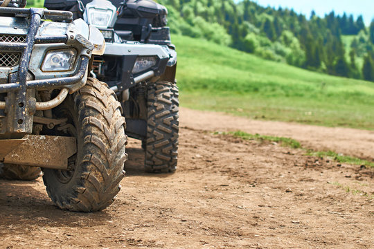Quadricycles or quadbikes on the ground road in summer mountains