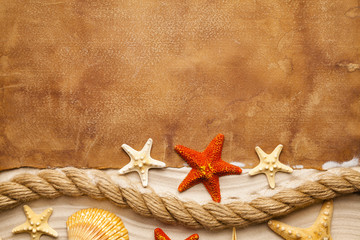Blank paper sheet, starfish, shell and rope on beach