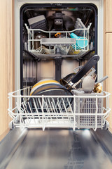 Photo of open dishwasher with dirty dishes