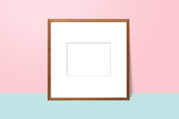 empty white space in wooden blank frame leaning against with pink wall and blue floor. simple blank photo frame for presentation or decorate background