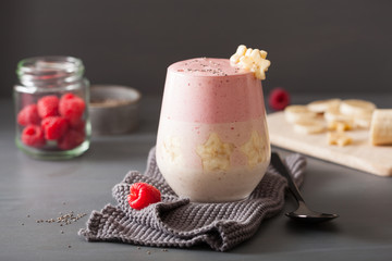 healthy layered raspberry banana smoothie in glass