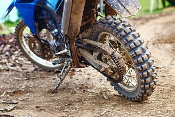 Single offroad mountain motorcycle or bike taking part in motocros competition parked on dirty terrain road