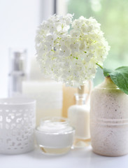 Fototapeta na wymiar White hydrangea with spa products on a white background