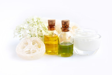 Spa composition with aroma oils, cream and flowers of hydrangea on white background