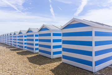 Blue and white striped beach huts at the seaside