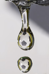 Lightweight football. Drops of clear water with reflection of soccer ball.