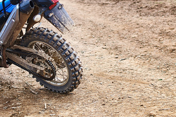 Single offroad mountain motorcycle or bike taking part in motocros competition parked on dirty terrain road