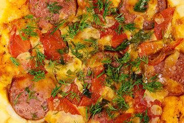 Obraz na płótnie Canvas Close-up of homemade delicious pizza with salami, tomatoes and dill