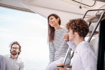 vacation, travel, sea, friendship and people concept - friends talking while having a sea travel to...