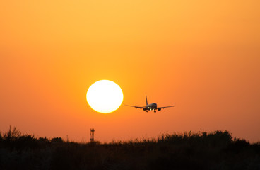 Fototapeta na wymiar Airplane and sunset