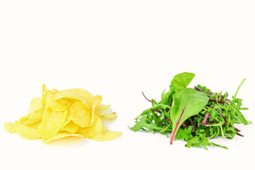 Fried potato crisps and healthy salad on a white background