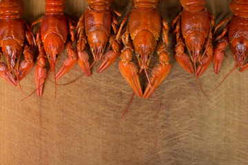 boiled crawfish on wooden desk cutting board food and drinks concept with empty space for copy or text