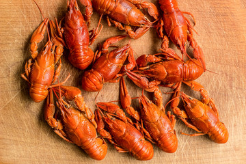 boiled crawfish on wooden desk cutting board food and drinks concept with empty space for copy or text