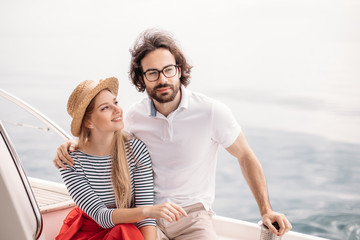 Caucasian attractive just married couple having their honeymoon trip on a luxury sailing boat at...