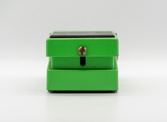 Green vintage guitar pedal isolated on white