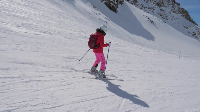 In Movement Side View, Woman Skier Skiing Downhill Of The Mountain Resort