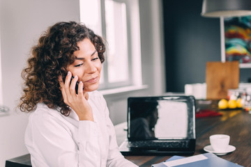 Fototapeta na wymiar Jewish business woman speaks by phone in the office.