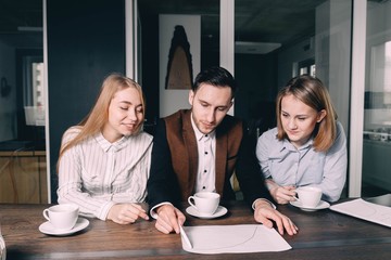 Office business people during a discussion, coffee pauses. One man and two women emotionally...