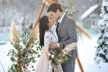 Winter wedding European bridegroom and Asian bride