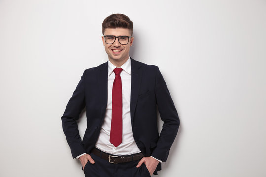 portrait of happy relaxed businessman with glasses standing