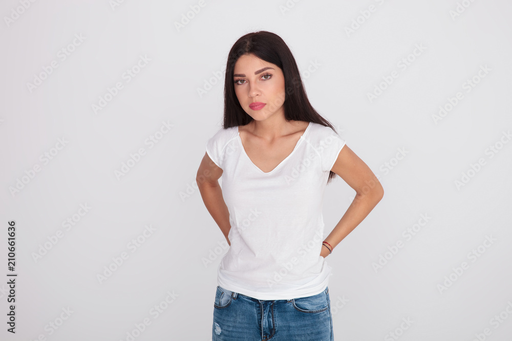 Wall mural beautiful brunette girl wearing a white t-shirt standing