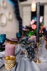 Details of decorating of a wedding: candles, flowers and candlesticks.