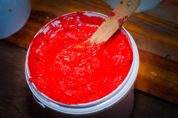 red color of plastisol ink in white plastic barrel. plastisol ink is specially for print on tee shirts and any fabric plastisol ink is oil type must clean and mix with oil