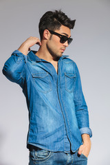 Fototapeta premium relaxed casual man with sunglasses looks down to side