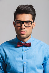 portrait of handsome young student with glasses and bowtie
