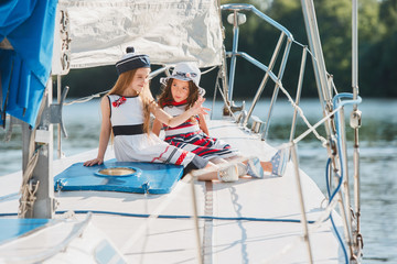 Obraz premium The children on board of sea yacht