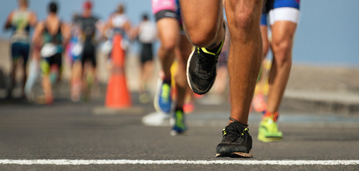 Marathon running race, runners feet on road - obrazy, fototapety, plakaty