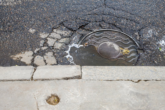 Manhole drain cover on streets of Moskow Russia.