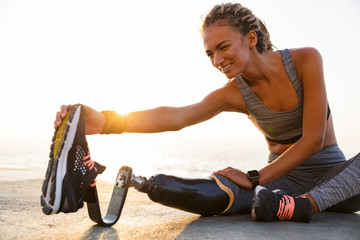 Cropped image of smiling disabled athlete woman