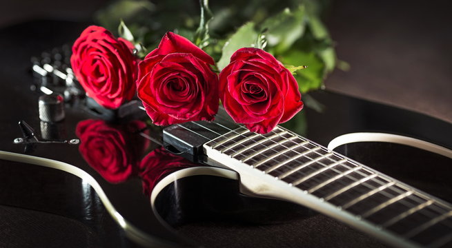 three roses on black guitar