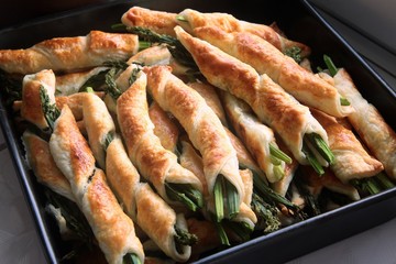 green sprouts of asparagus in dough