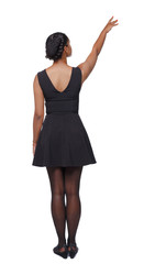 back view of a black African-American woman in a brown dress pointing upwards.