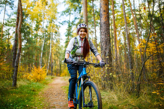 Photo of girl in helmet riding on bike